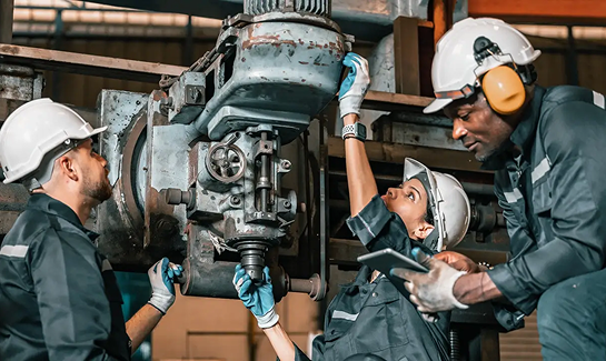 Engineers working on hydraulic machinery