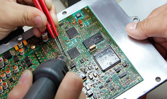 Technician repairing an electronic circuit board